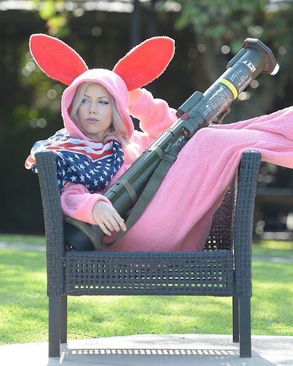 women with Easter Bunny outfit, American flag, and missile launcher