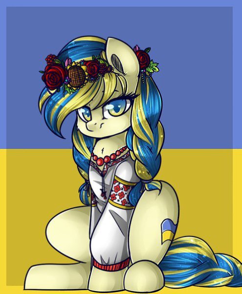 pony in Ukraine colors crouches in front of Ukraine flag