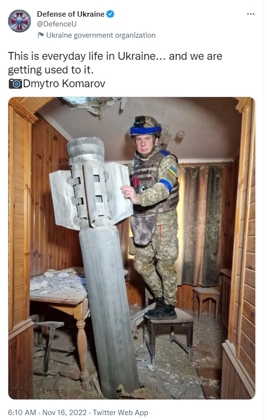 Ukraine soldier standing next to a missile that hit a house, caption 'This is everyday life in Ukraine... and we are getting used to it.