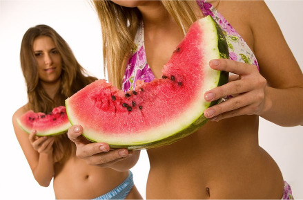 cute women holding watermelon slices