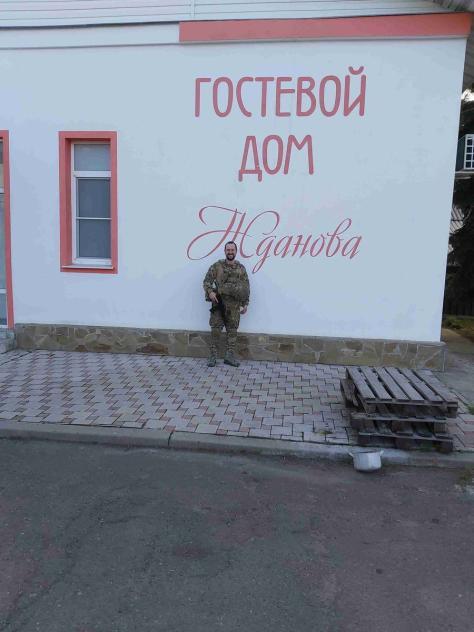 Wagner CEO's son standing in front of a building.