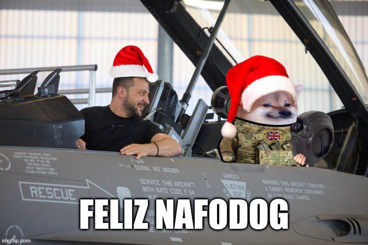 Zelenskyy and fella sitting in plane, captioned 'Feliz Nafodog'.