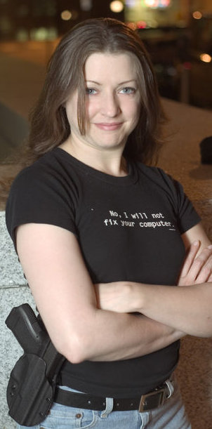 woman with 9mm and an 'I will not fix your computer' shirt