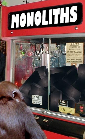 chimp looking at a vending machine that sells monoliths