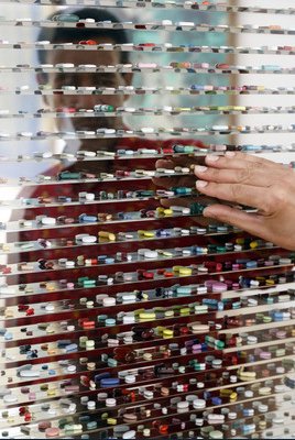 art depicting a human behind a bunch of transparent boxes, each with a pill in it