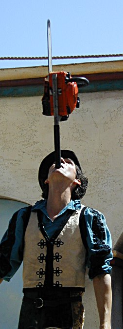 Dextre Tripp balancing a chainsaw on his chin