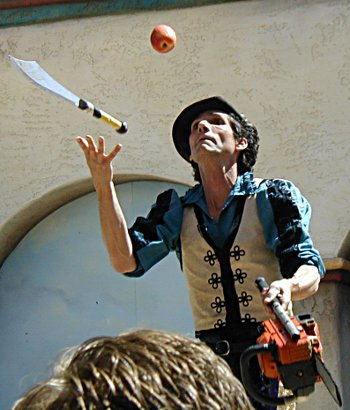 Dextre Tripp juggling a knife, apple, and chainsaw