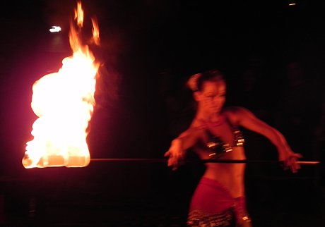 woman dancing with a flaming baton