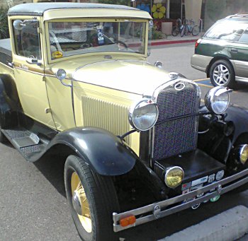 very old Ford car in parking lot