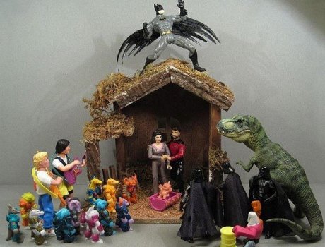 Nativity scene with Troi and Riker as Mary and Joseph, three wise Darth Vaders, Bill and Ted as shepherds, Batman as an angel, and dinosaurs and Battle Beasts as animals