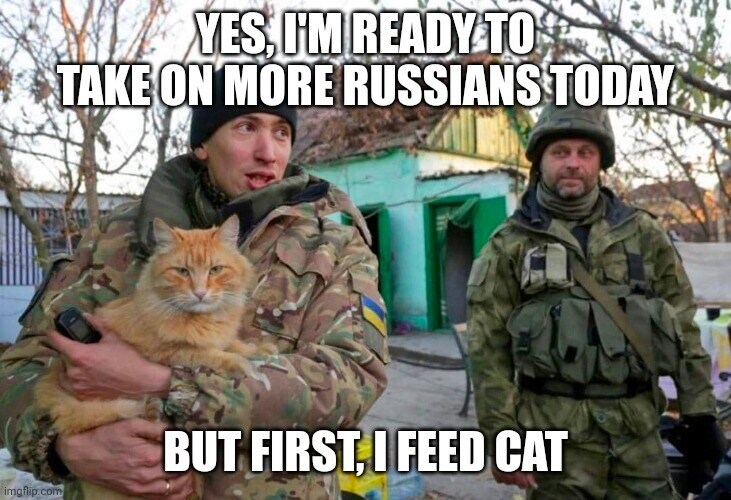2 Ukraine soldiers, the one holding an orange cat says, 'Yes, I'm ready to take on more Russians today, but first, I feed cat.'