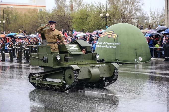 a 90 year old mini tank in a parade