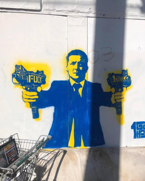 graffiti showing Zelenskyy with machine guns