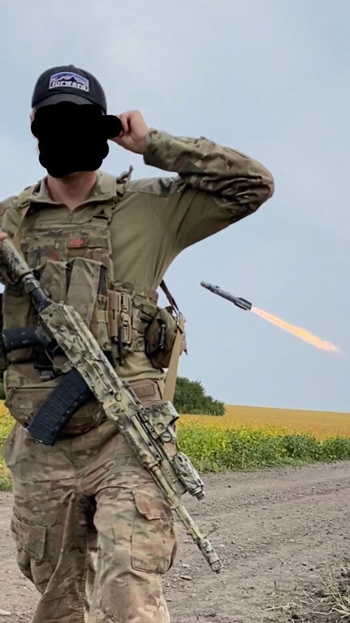 soldier with a missile being launched behind him