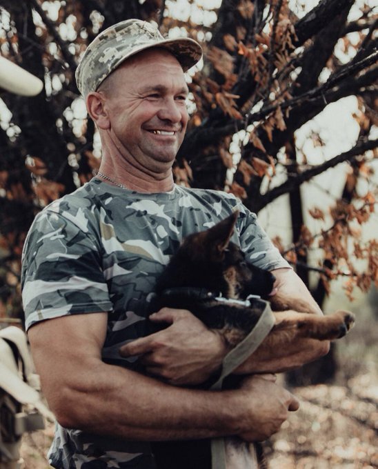 Ukrainian soldier holds dog