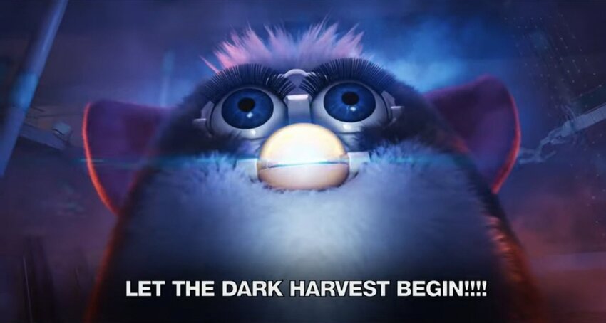 Furby in ominous lighting, captioned 'Let the dark harvest begin!!!'