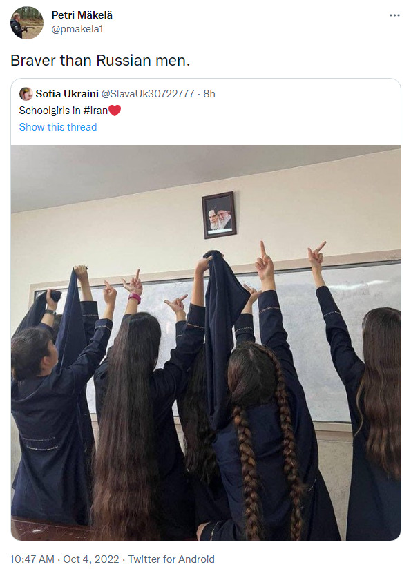 young women in Iran all give the finger to a picture of the Ayatollah, captioned 'Braver than Russian men'
