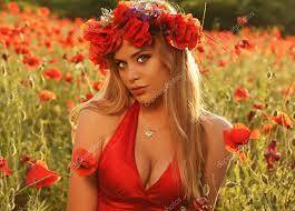 cute woman in red in a field of poppies