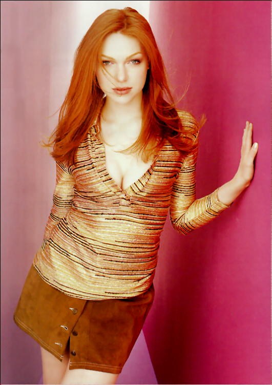 redhead (Laura Prepon) in striped top and miniskirt
