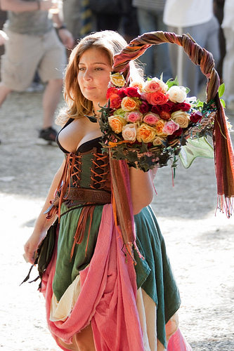 girl carrying flowers at a Ren Faire