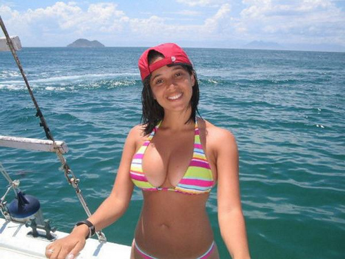 brunette with baseball cap fishing