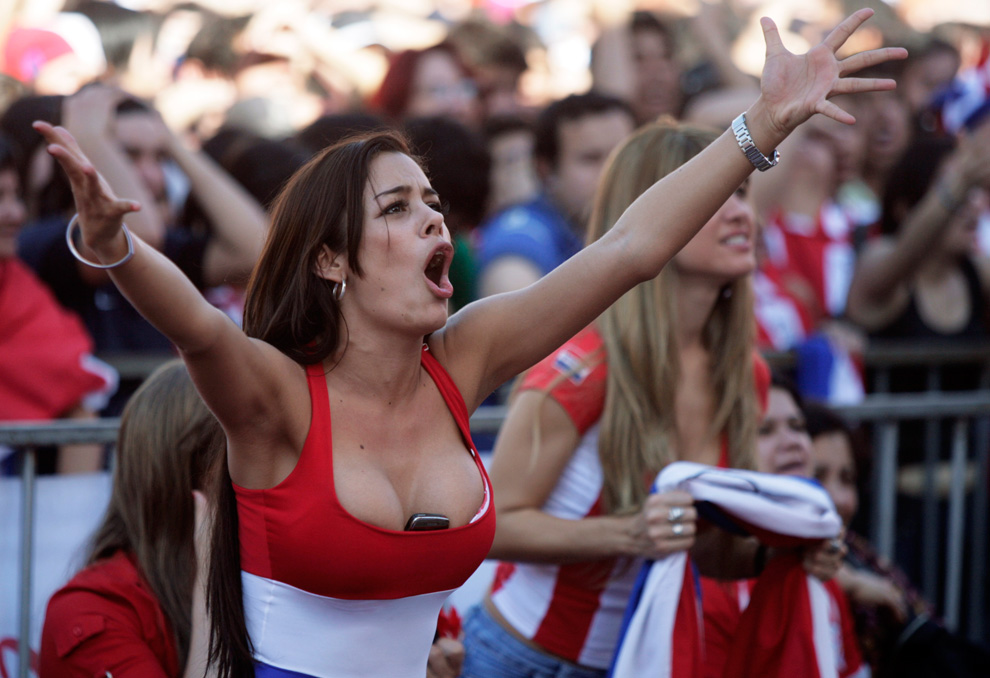 soccer fan with a cellphone in her cleavage